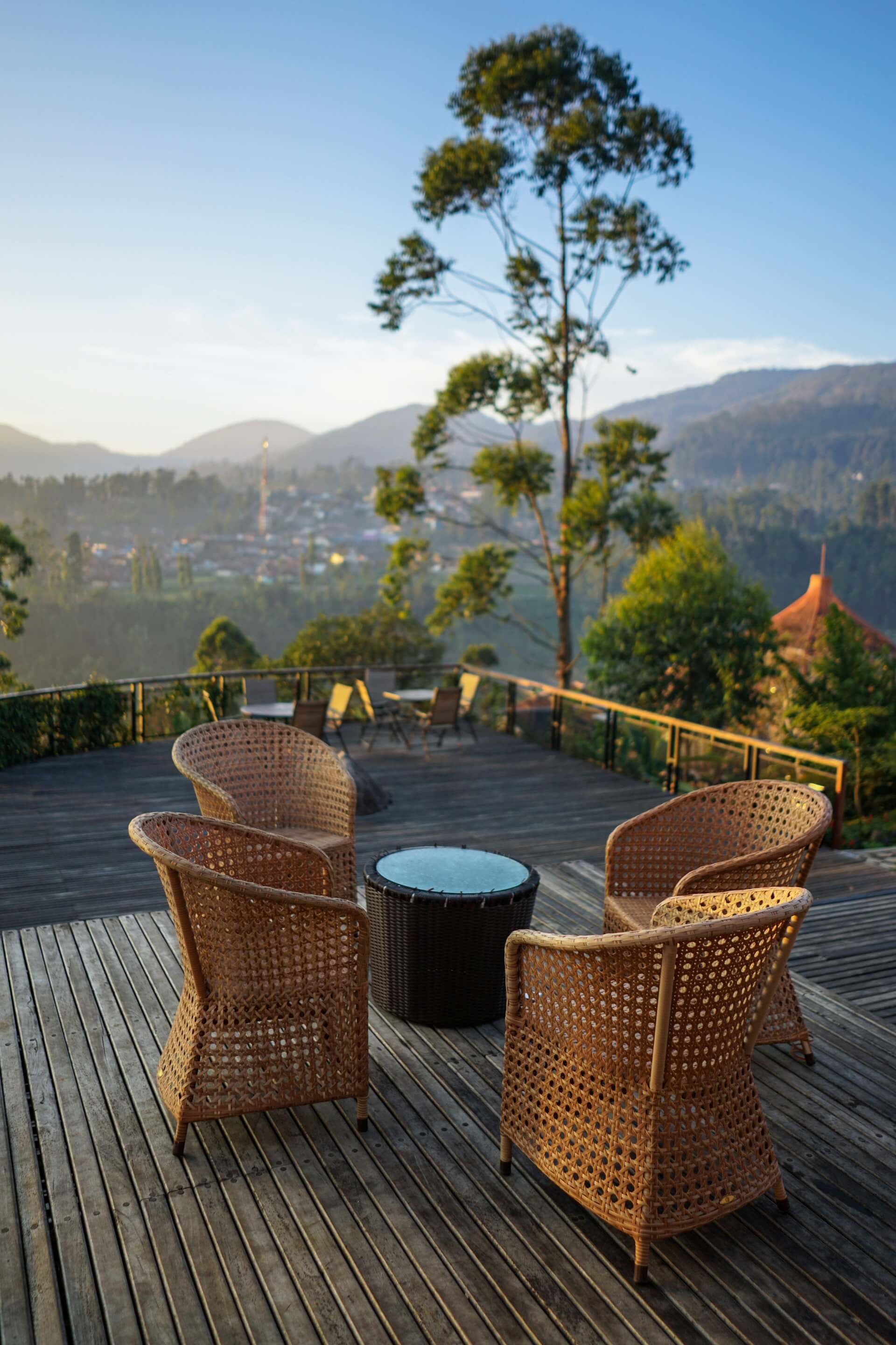 An outdoor wooden deck with a table and chairs.